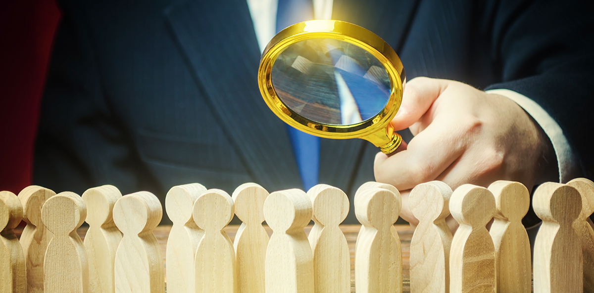 Man using a magnifying glass to search for something